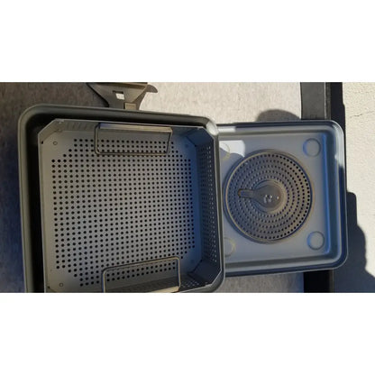 Gray plastic case medical half size sterilization tray with perforated sides and circular grated insert for medical use