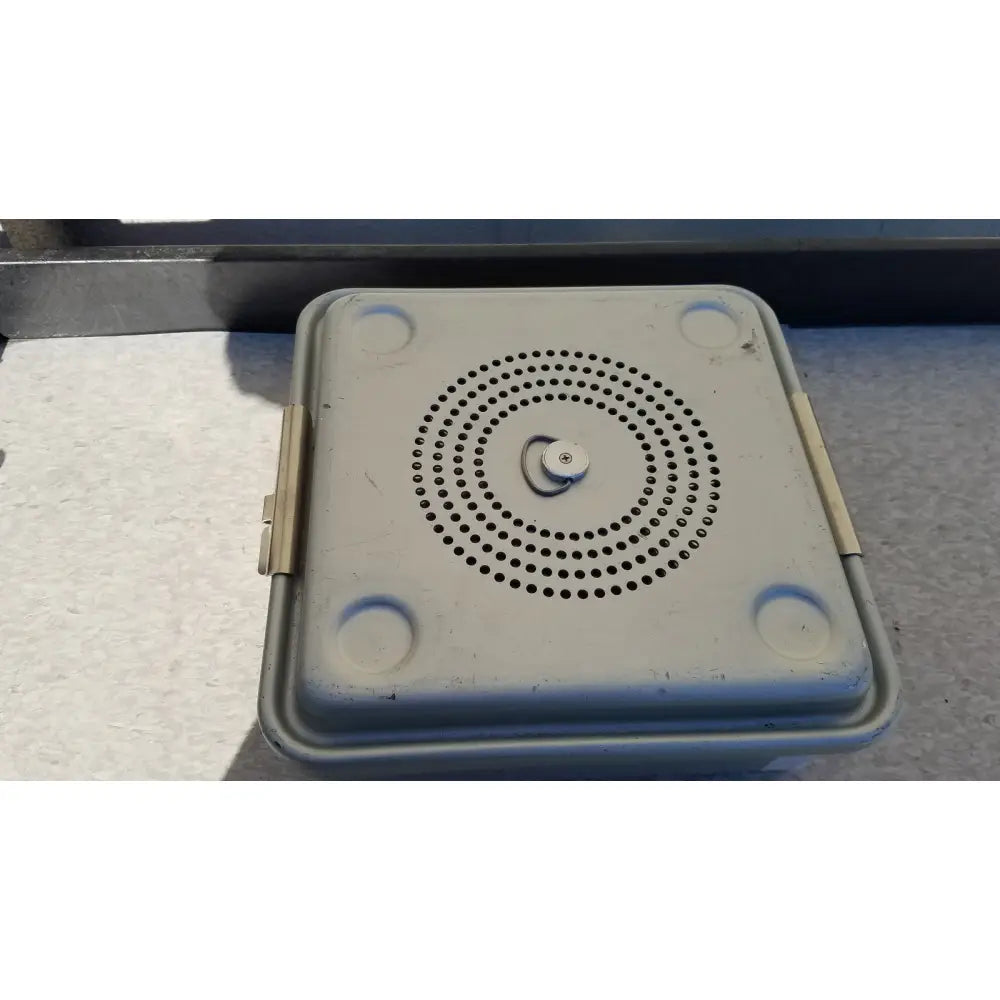 Gray plastic case medical half size sterilization case with circular perforations on lid and rounded corner handles