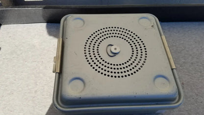 Gray plastic case medical half size sterilization case with circular perforations on lid and rounded corner handles