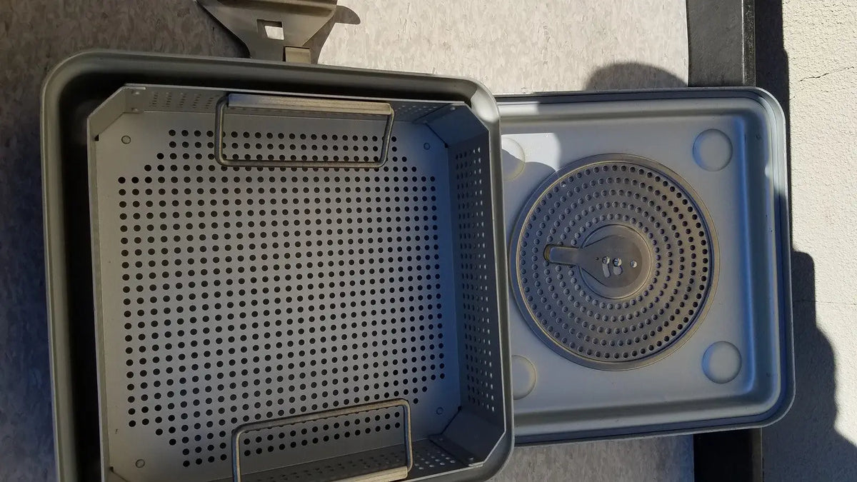 Gray plastic case medical half size sterilization tray with perforated sides and circular grated insert for medical use