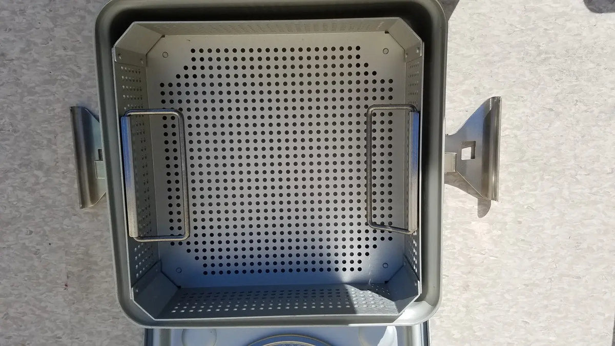 Gray perforated metal grill basket with two side handles for case medical half size sterilization use