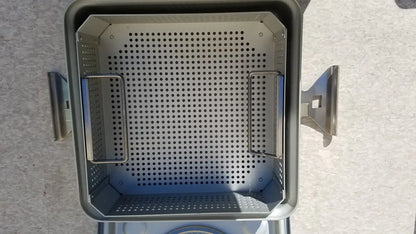 Gray perforated metal grill basket with two side handles for case medical half size sterilization use