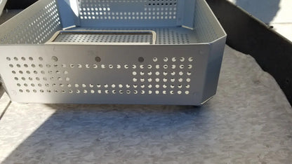 Silver perforated metal storage basket with a rectangular inner tray in case medical half size sterilization case and lid