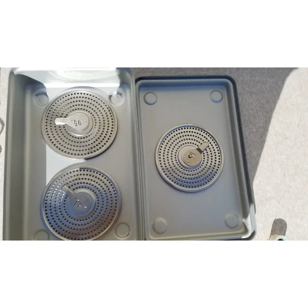 Silver circular gas burner grates with perforated surfaces and control knobs in case medical karl storz ks z-39311as container