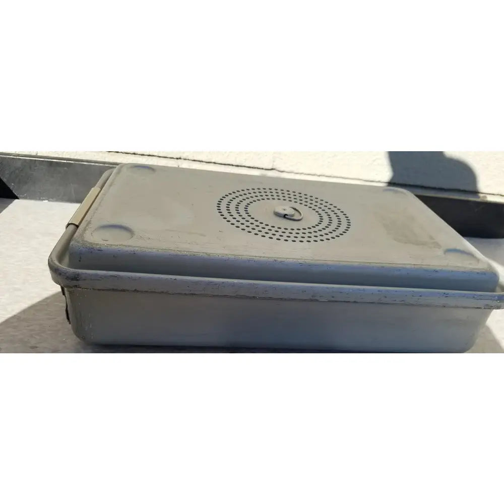 Gray plastic medical karl storz storage and sterilization container with circular perforated pattern and metal latch