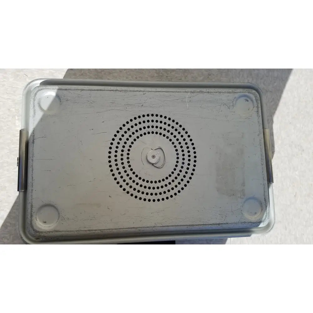 Silver metallic rectangular case medical karl storz storage and sterilization container with circular perforations and rounded corners
