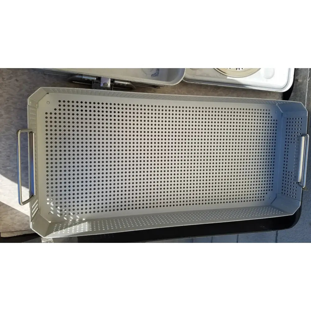 Silver perforated metal baking tray with reinforced handles and raised rim in case medical karl storz ksz 39402as container