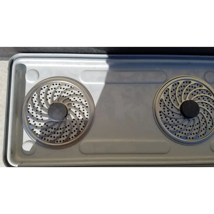 Two circular metallic burner grates with spiral pattern on stainless steel stovetop for case medical karl storz ksz 39402as container