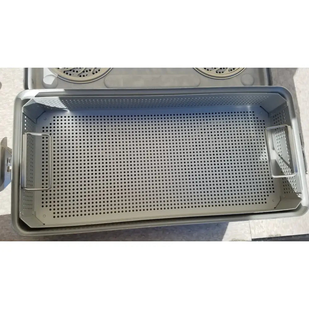 Gray perforated metal sterilization tray with reinforced side handles in case medical karl storz ksz 39402as container