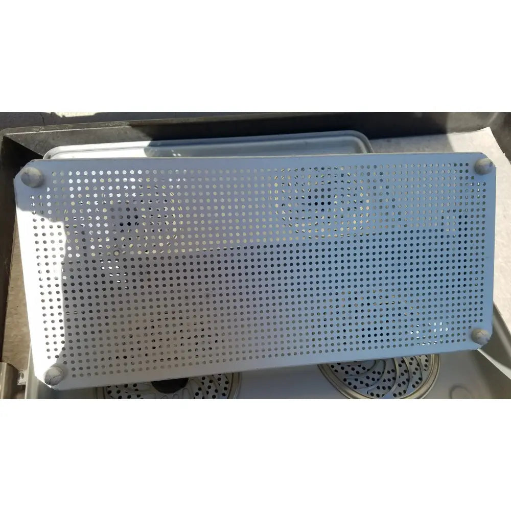 Light blue perforated metal tray with rounded corners and four corner caps in medical karl storz ksz 39402as case