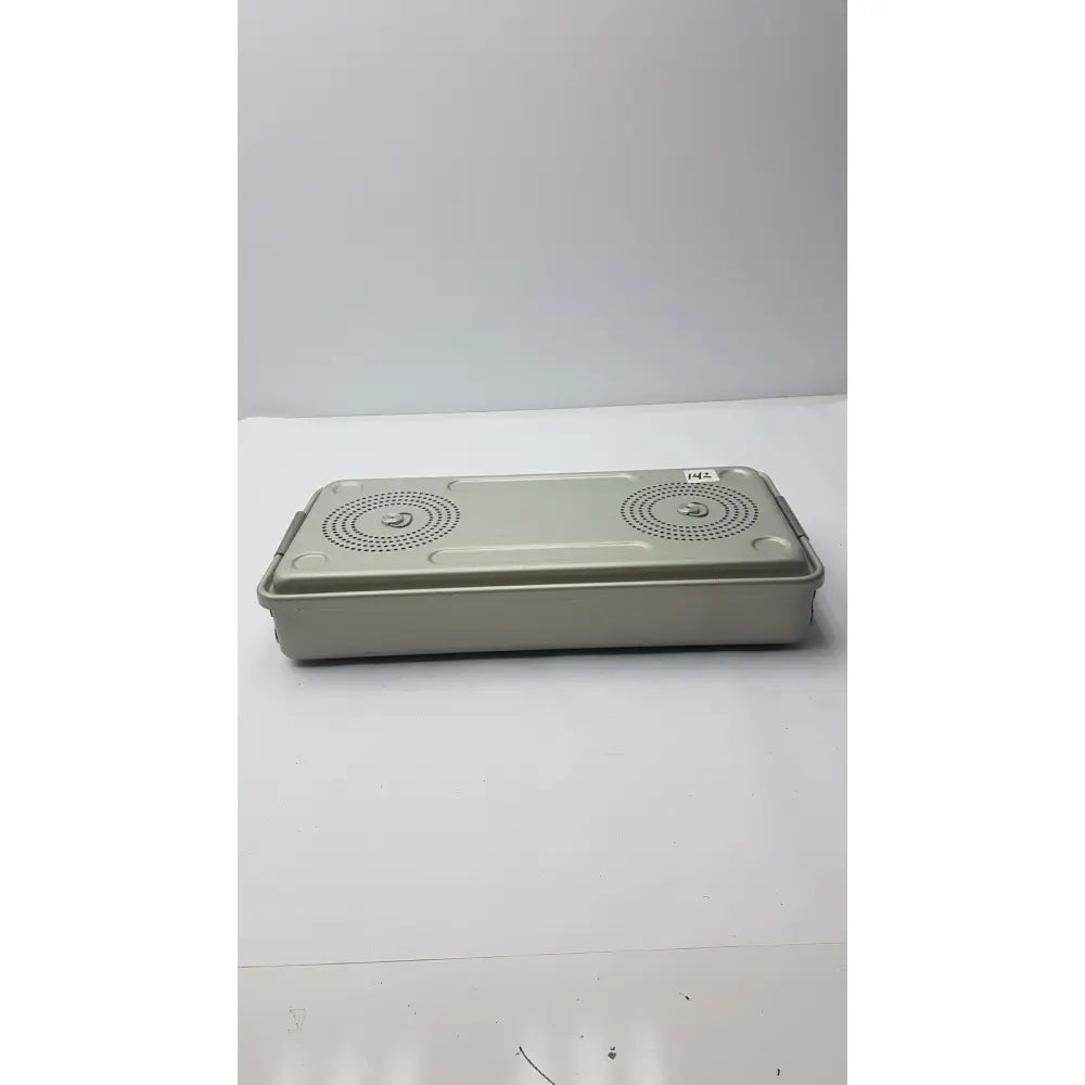Beige rectangular solid sterilization container by Case Medical with perforated lid for secure sterile storage