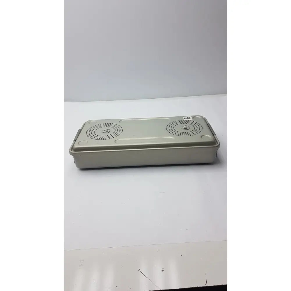 Beige rectangular solid sterilization container box with two circular perforated patterns on lid by case medical
