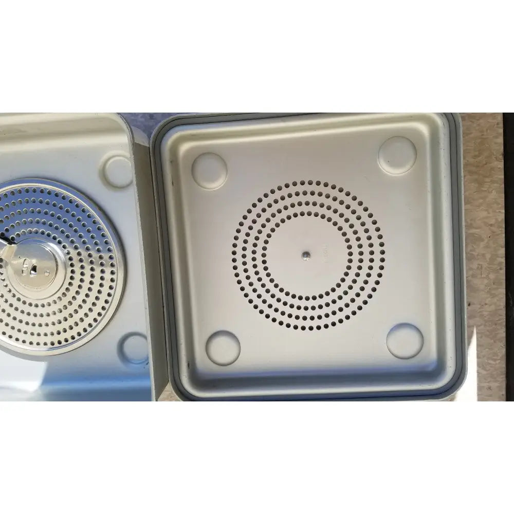 Silver-colored square speaker grille with circular perforations and rounded corners for case medical sterilization container half size lid