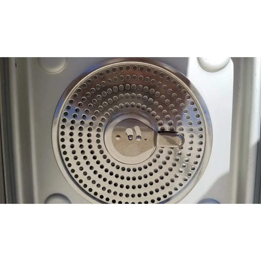 Circular stainless steel perforated filter with central latch in case medical sterilization container half size lid
