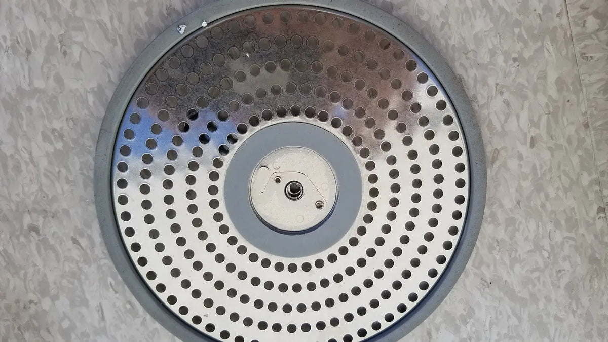 Gray circular case medical sterilization container half size lid with perforated metal surface and concentric hole rings