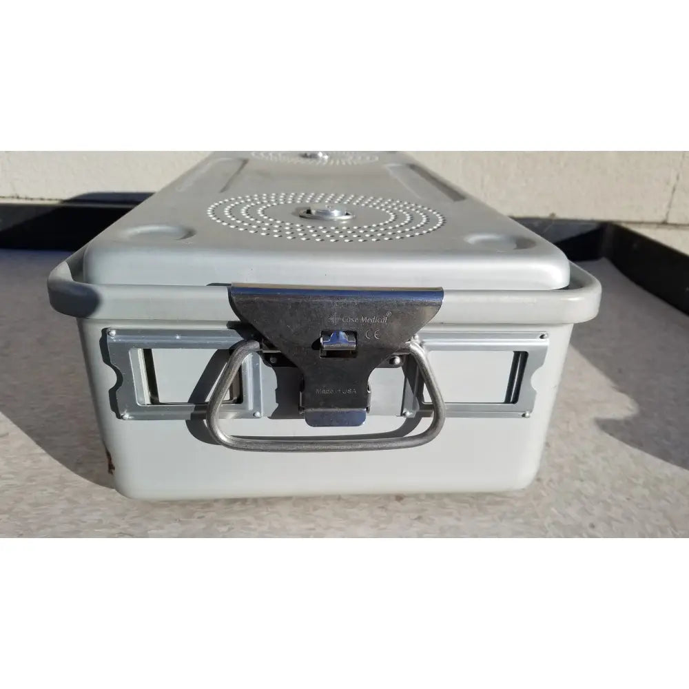 Gray plastic case medical storage container with metal latch, handle, and circular perforated pattern on the lid