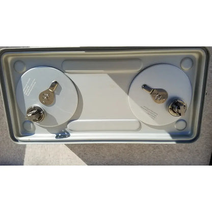 Silver-colored metal case medical storage tray with two cylindrical batteries secured by metallic terminals and keyholes