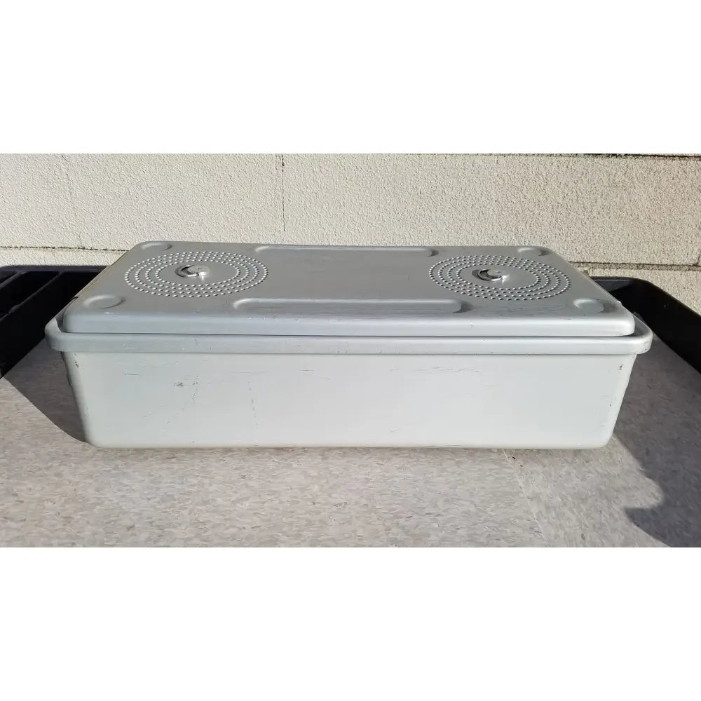 Gray plastic case medical storage container with matching lid, circular textured patterns, and small handles for sterilization