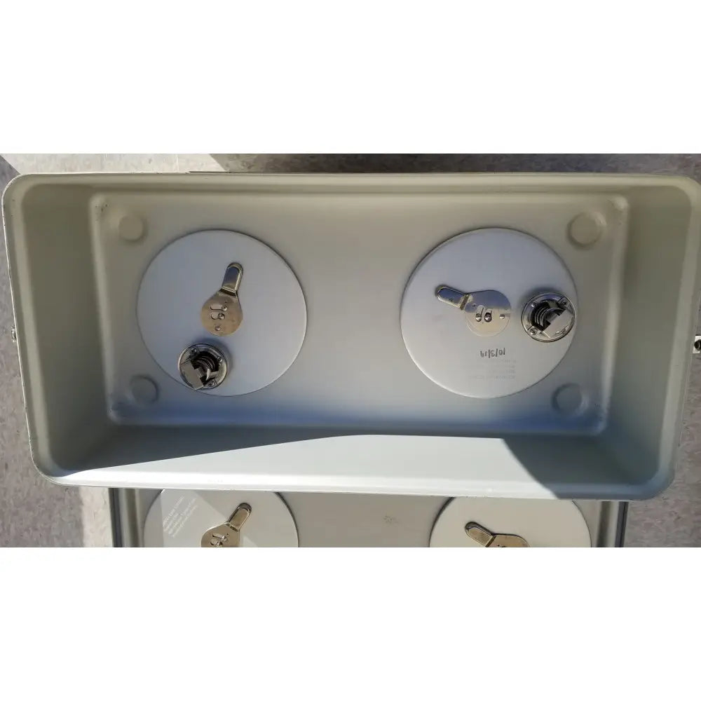 Gray plastic case medical storage container with two circular access panels, silver keyholes, and metallic latches