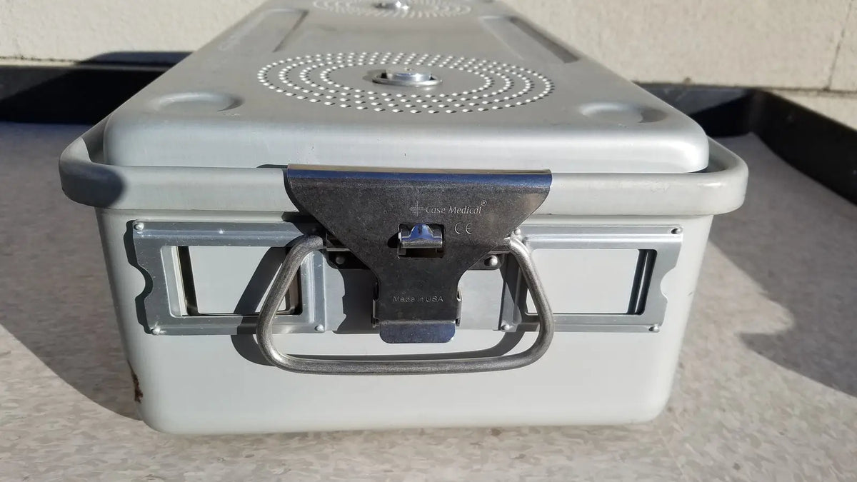 Gray plastic case medical storage container with metal latch, handle, and circular perforated pattern on the lid