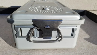 Gray plastic case medical storage container with metal latch, handle, and circular perforated pattern on the lid