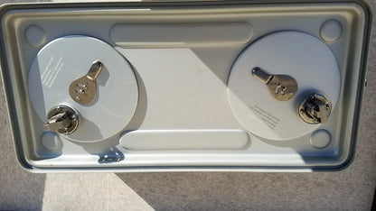 Silver-colored metal case medical storage tray with two cylindrical batteries secured by metallic terminals and keyholes