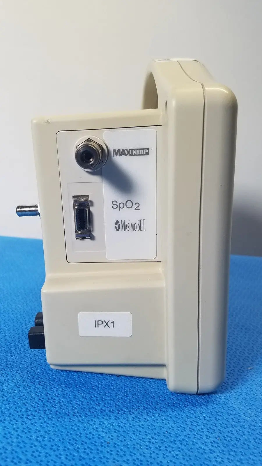 Beige casmed 740 masimo set spo2 blood pressure patient monitor back panel with circular port and rectangular connector