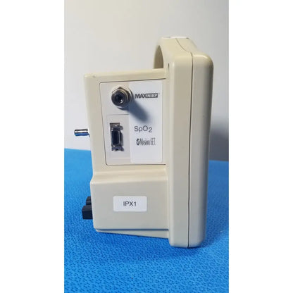 Beige casmed 740 masimo set spo2 blood pressure patient monitor back panel with circular port and rectangular connector