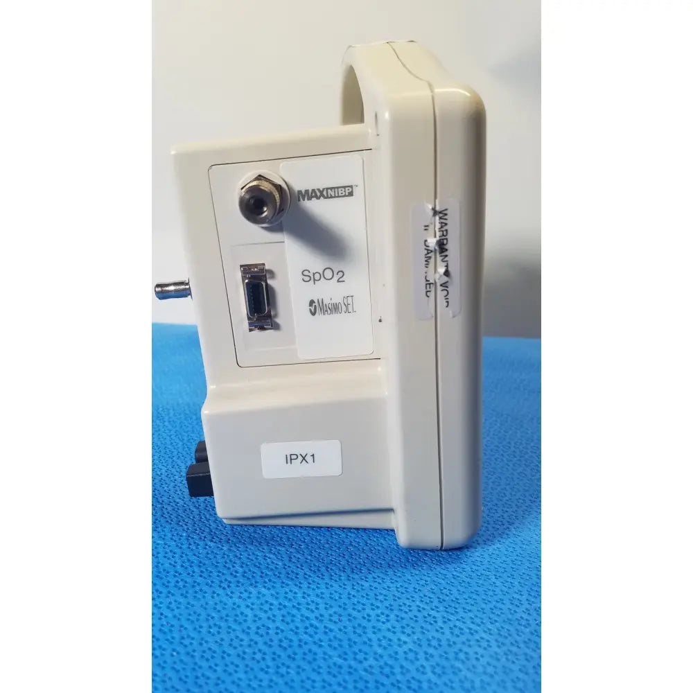 Beige plastic casmed 740 masimo set spo2 blood pressure patient monitor with metallic connector and usb port visible