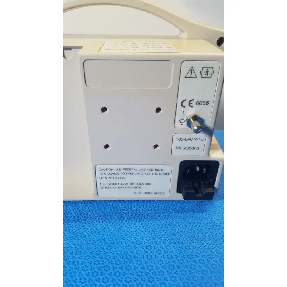 Cream-colored casmed 740 masimo set spo2 blood pressure patient monitor back with power input and regulatory compliance labels