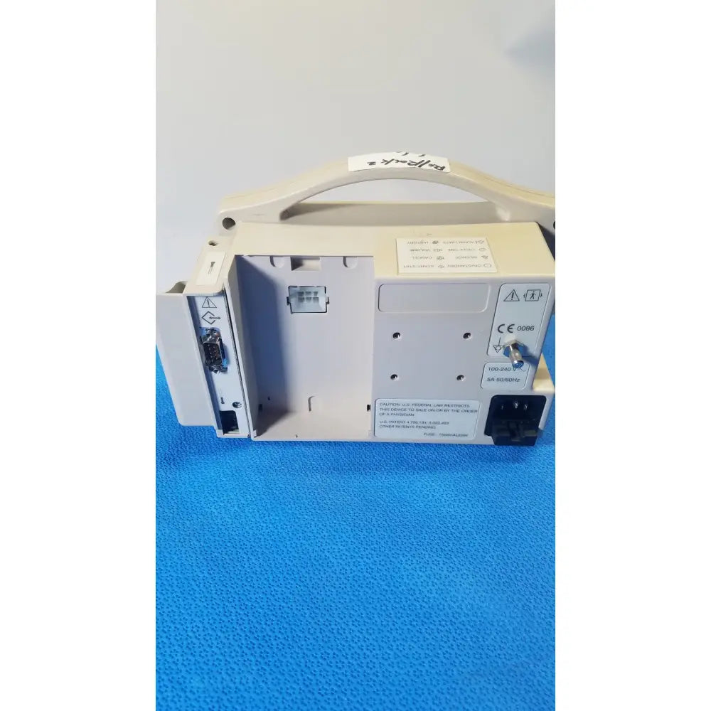 Beige casmed 740 masimo set spo2 blood pressure patient monitor showing handle and multiple ports on the back
