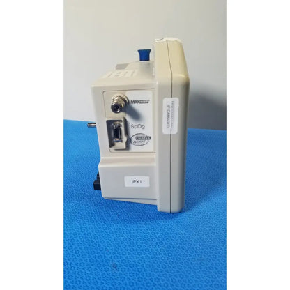 Beige casmed 740 max nibp spo2 blood pressure patient monitor with blue knob and labeled ports for spo2 blood use
