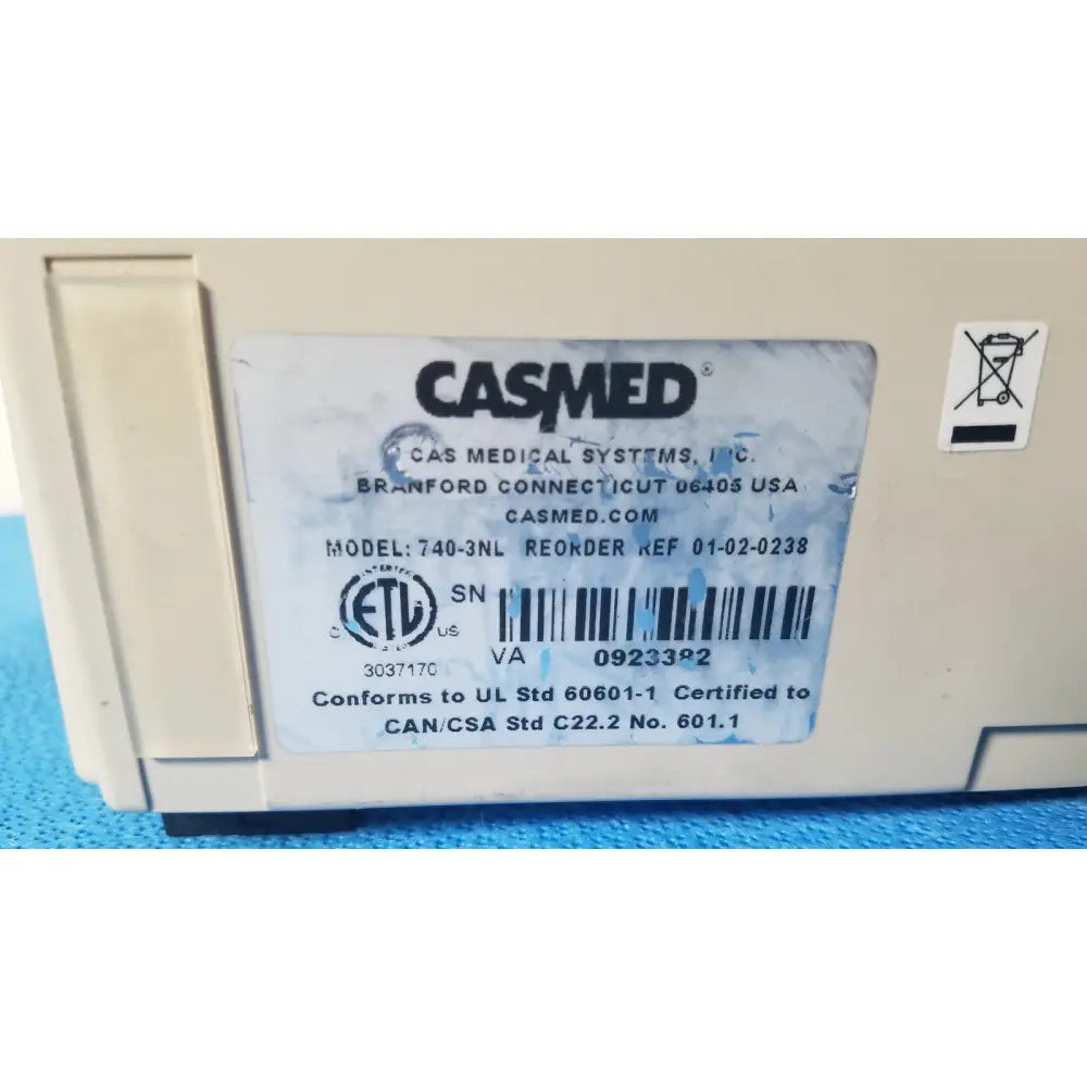 Beige casmed 740-3nl max nibp spo2 patient monitor showing certification label and serial number details on back side