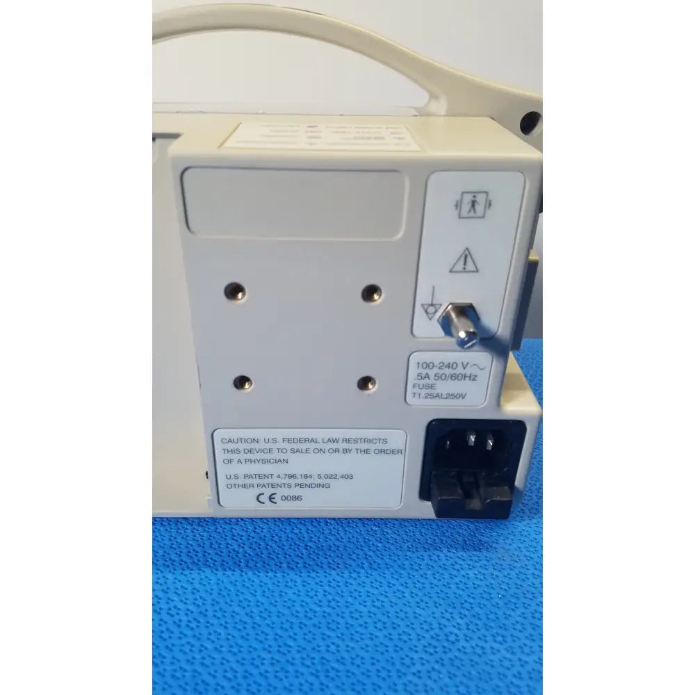 Beige back side of casmed 740 max nibp spo2 patient monitor showing power input port warning symbols and regulatory labels