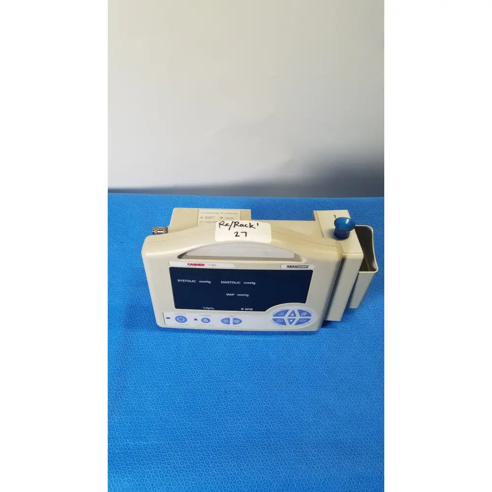 Beige casmed 740 max nibp spo2 blood pressure patient monitor with blue screen displaying vital signs and blue knob