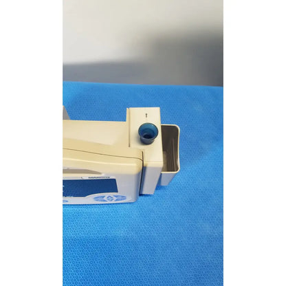 Beige and blue casmed 740 max nibp vital signs monitor with a dark blue circular component on top