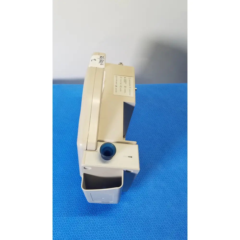 Beige casmed 740 max nibp vital signs monitor showing a blue circular port and label on the top surface