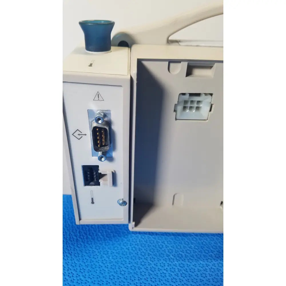 Back view of CASMED 740 Max NIBP vital signs monitor in gray with blue knob and multiple ports including RS-232 and ethernet