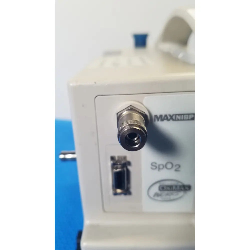 Beige casmed 740 max nibp vital signs monitor with metallic threaded port and oval-shaped label for accurate monitoring