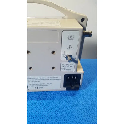 Beige casmed 740 max nibp vital signs monitor back side showing power input port and warning labels