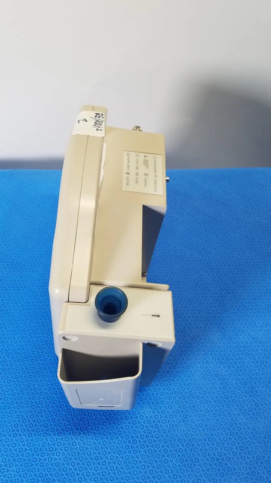 Beige casmed 740 max nibp vital signs monitor showing a blue circular port and label on the top surface
