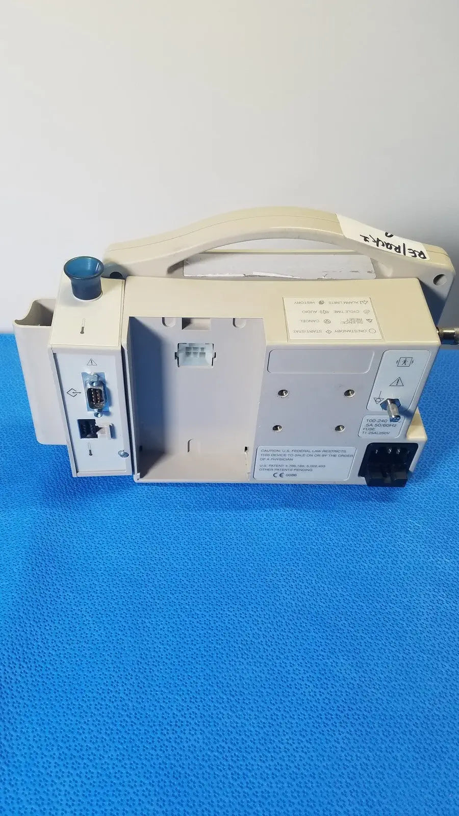 Beige casmed 740 max nibp vital signs monitor with handle and multiple ports on its side for medical use