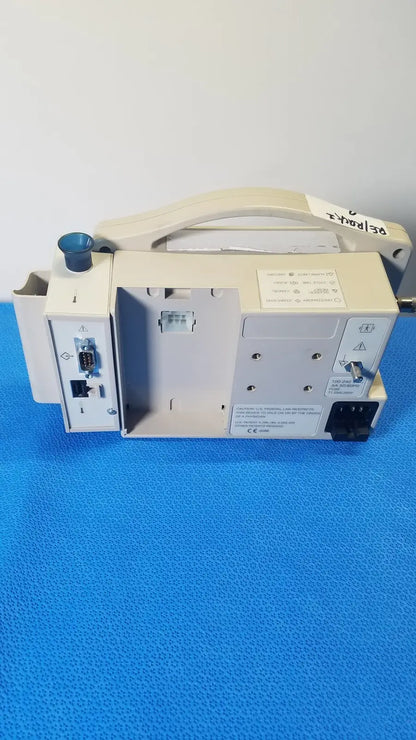 Beige casmed 740 max nibp vital signs monitor with handle and multiple ports on its side for medical use