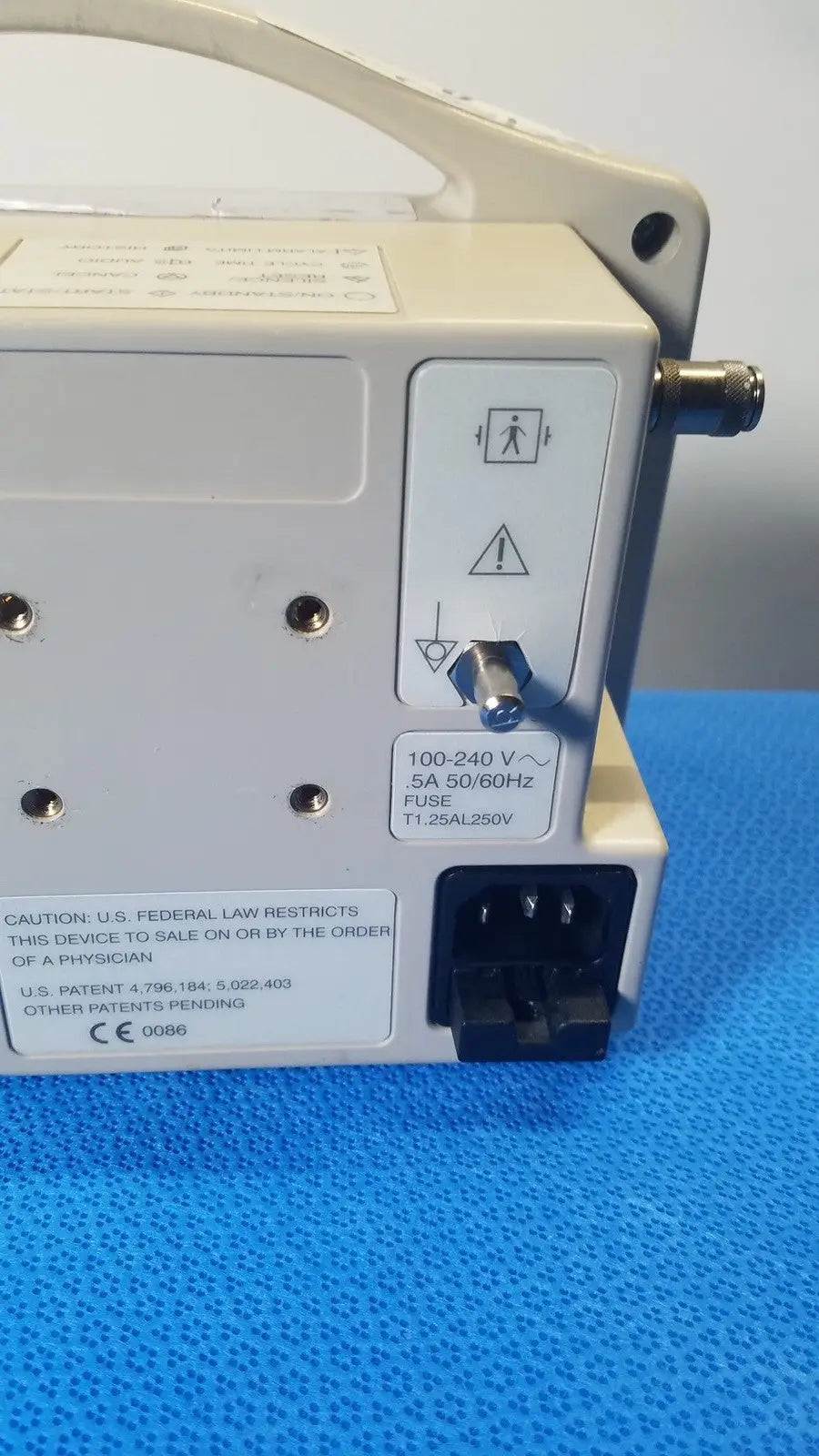 Beige casmed 740 max nibp vital signs monitor back side showing power input port and warning labels