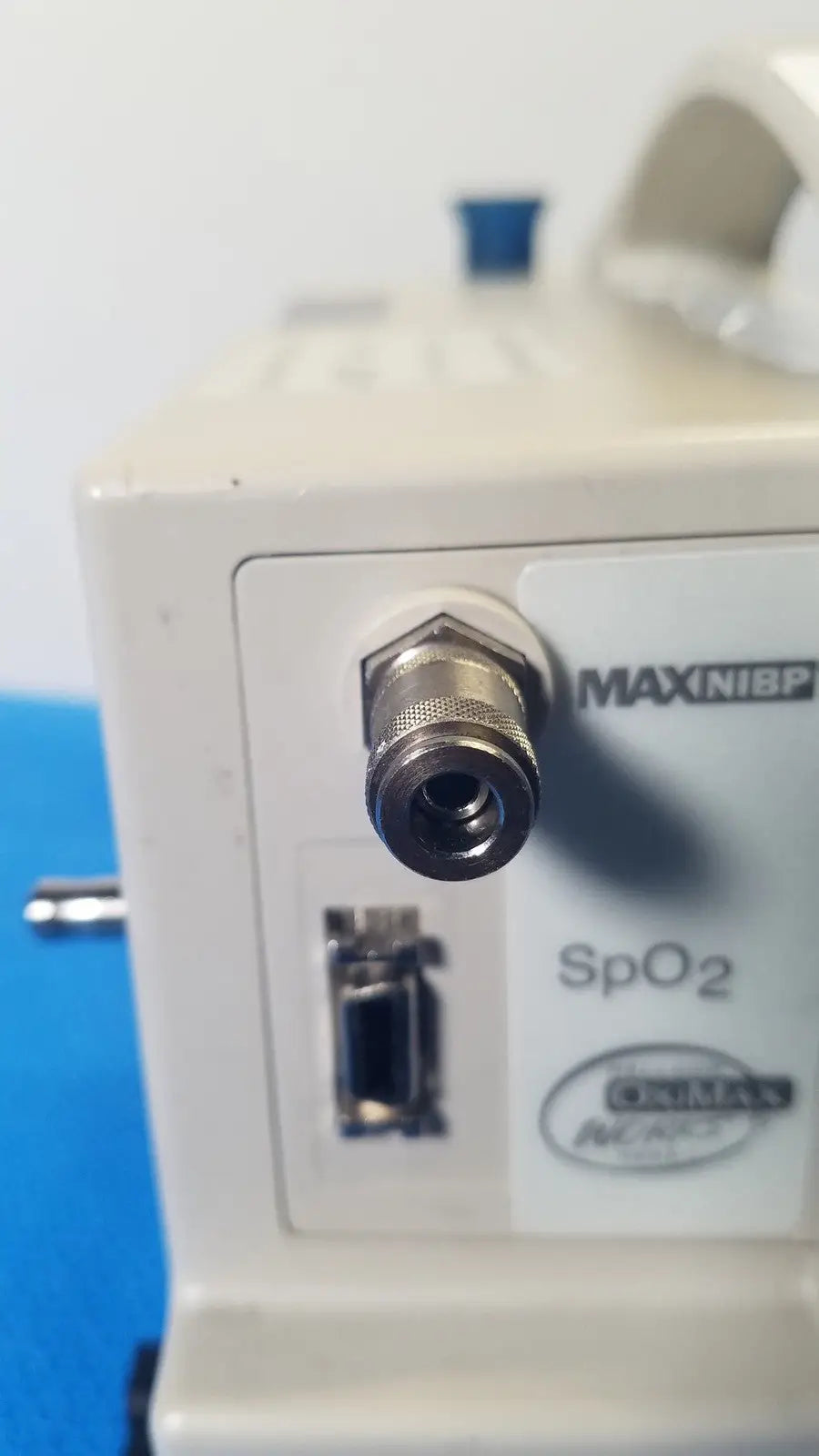 Beige casmed 740 max nibp vital signs monitor with metallic threaded port and oval-shaped label for accurate monitoring