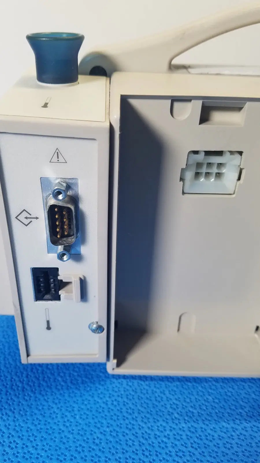 Back view of CASMED 740 Max NIBP vital signs monitor in gray with blue knob and multiple ports including RS-232 and ethernet