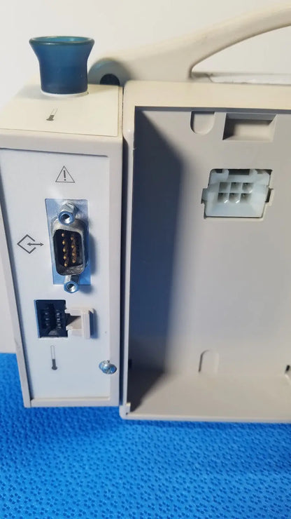 Back view of CASMED 740 Max NIBP vital signs monitor in gray with blue knob and multiple ports including RS-232 and ethernet