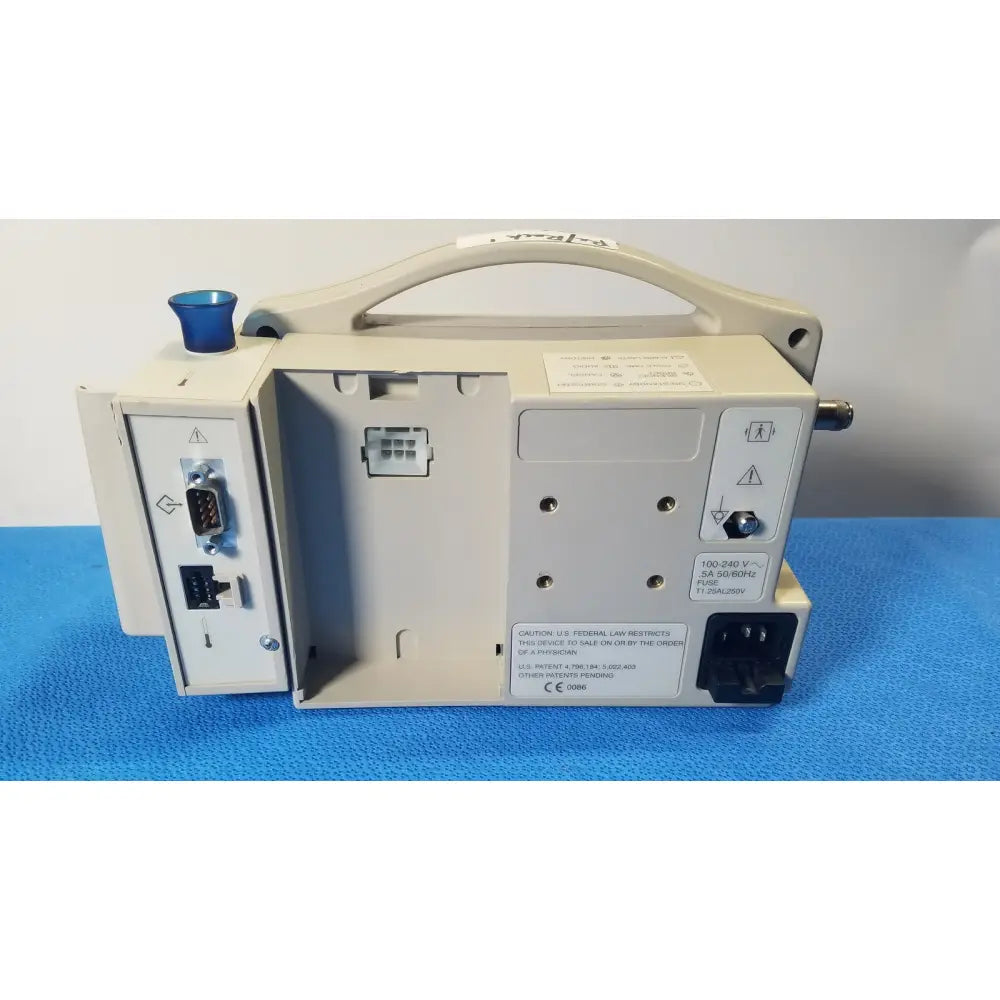 Beige casmed 740 patient monitor nibp with blue knob and multiple ports showing nibp spo2 masimo features on side