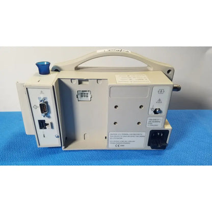 Beige casmed 740 patient monitor nibp with blue knob and multiple ports showing nibp spo2 masimo features on side