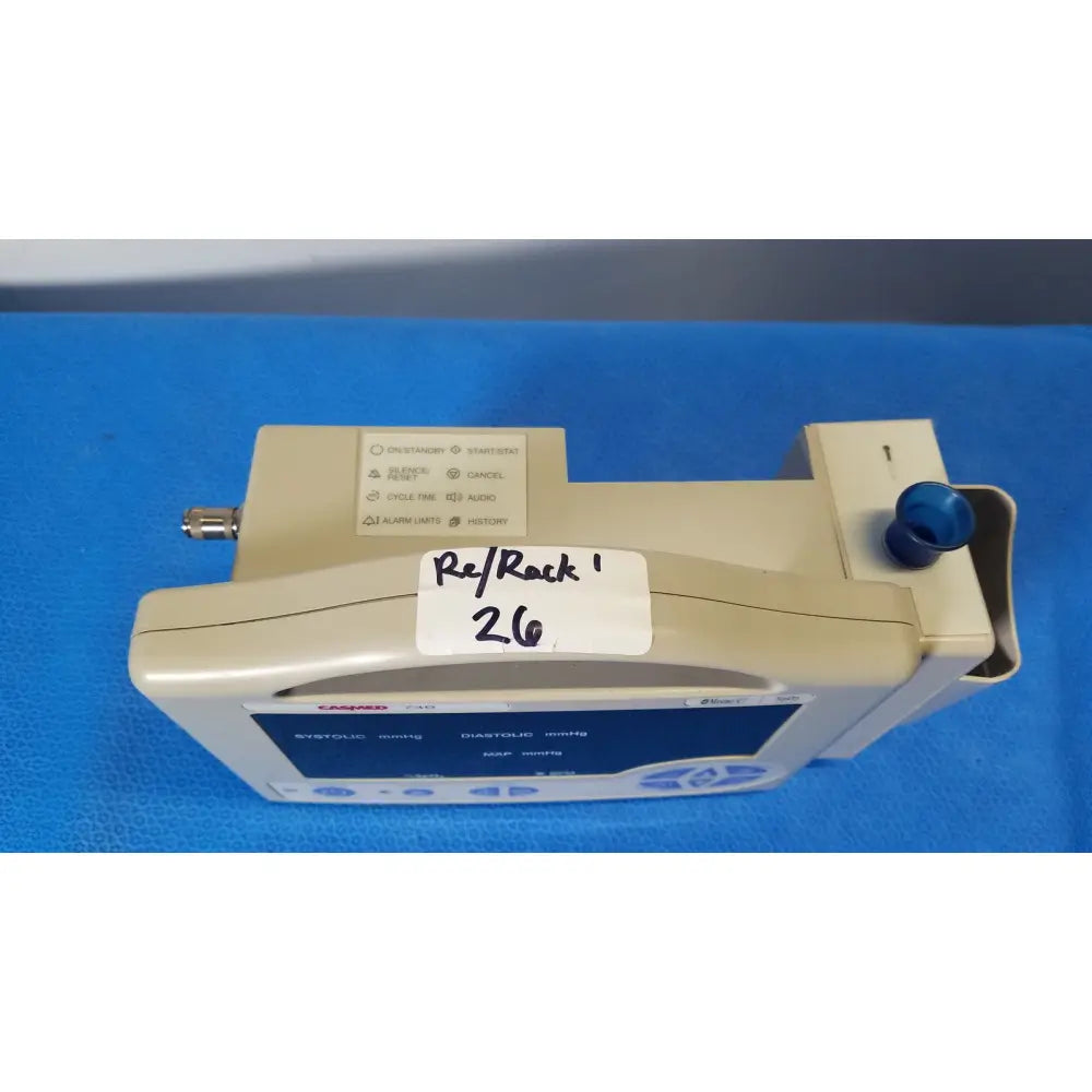 Beige casmed 740 patient monitor nibp with blue knob and labeled sticker for nibp spo2 masimo blood pressure monitoring